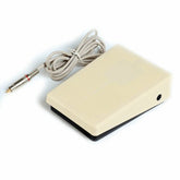 Solong P218 Tattoo Foot Pedal Switch. Beige rectangular pedal with textured top, connected to a grey cable with an RCA plug.